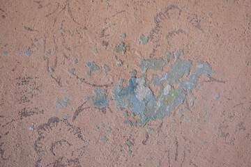 Peeled texture of an old wall of pinkish blue color.
