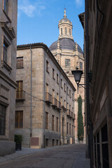 Fototapeta na wymiar Typical streets of the city of Salamanca with views of the Pontifical University and the Clerecia (name given to the building of the former Real Colegio del Espíritu Santo). 