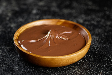 Wooden plate with hazelnut butter. 