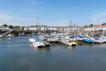 Fototapeta na wymiar Anstruther, United Kingdom - July 16, 2022: Harbour with boats on a sunny day
