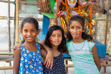 Girls Children standing in front of statues of the goddess