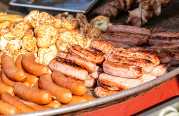 Obraz na płótnie Canvas Barbecue sausage and vegetables in a big frying pan