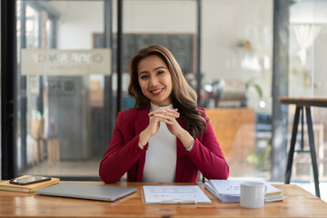 Young woman working with a laptop. Female freelancer connecting to internet via computer. Businesswoman at work.