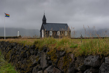 The Budakirkja church and a rainbow flag in Iceland
