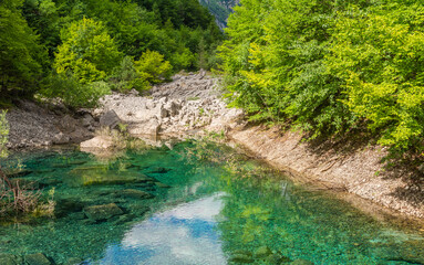 Naklejka na ściany i meble the ephemeral ponds of Tovel: small pearls with turquoise and indigo hues set within the basins of the extensive stony ground of Tovel’s Glares - Trentino Alto Adige,Italy