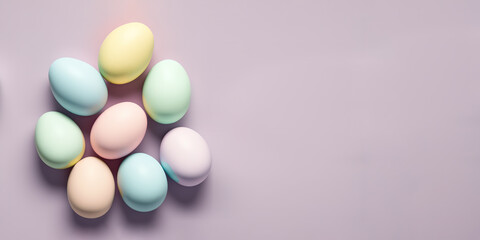 Top down view of easter eggs in pastel colours on neutral background, copy space.