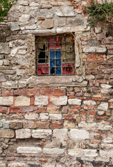 Fototapeta na wymiar Grunge wall background with weathered stones texture, old window
