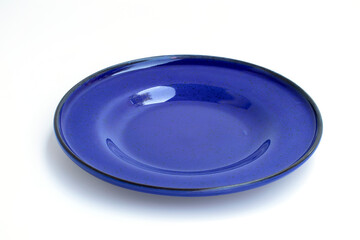 Round ceramic empty plate Dark blue isolate on white background, top view, cut out
