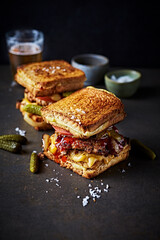 Crispy ground beef with pickled gherkins and onion in a grilled cheese sandwich