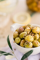 Various olives flavored with spices in white cup and glass jar. Green olives, black olives. Front and top shot on a white background