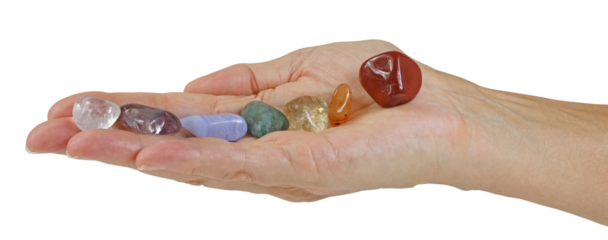 Open flat female hand with seven tumbled chakra coloured stones neatly balanced in a row transparent png file 