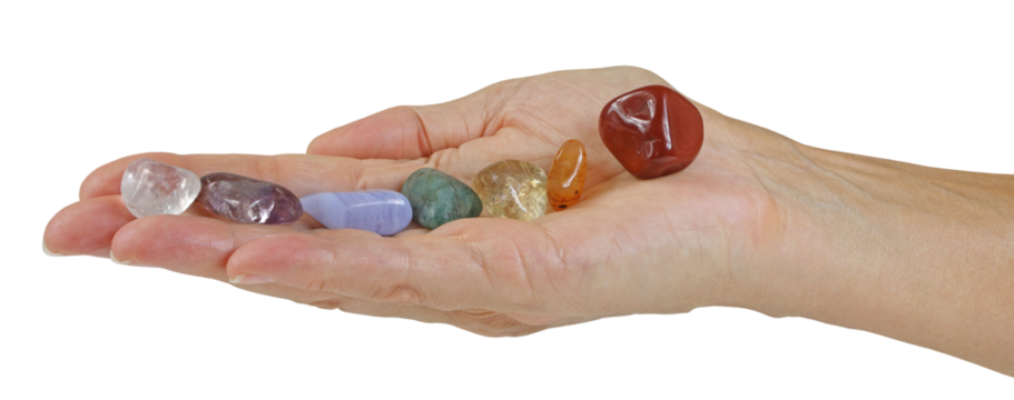 Open flat female hand with seven tumbled chakra coloured stones neatly balanced in a row transparent png file 