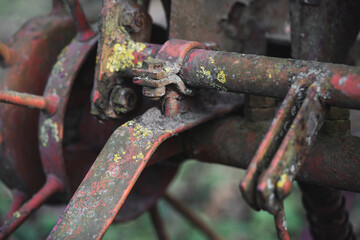 old rusty metal spare parts for work in agriculture