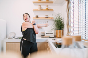 chubby woman stretching arms improve movement. relax fat woman training home fitness trying twisting arms for stretching. chubby woman focus warming before or after exercising reduce muscle tension