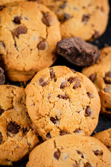 Cookies with pieces of milk chocolate on the table. 