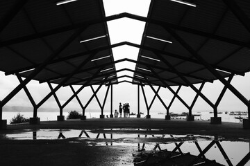 Black and white photo, Monochrome photo of a symmetrical building roof silhouette on the beach in Pangandaran area - Indonesia