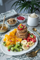 Pancakes with fresh fruit. Fruit salad with gluten-free pancakes. Healthy breakfast full of vitamins