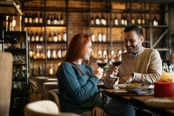 Valentines day couple sitting in favourite caffe, exchanging gifts in hart shape, couple cudling and hugging