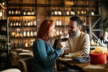 Valentines day couple sitting in favourite caffe, exchanging gifts in hart shape, couple cudling and hugging