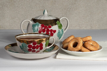 tea set with cookies on a white tablecloth