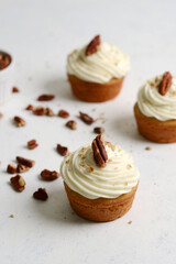 closeup of pecan buttercream cupcakes with nuts