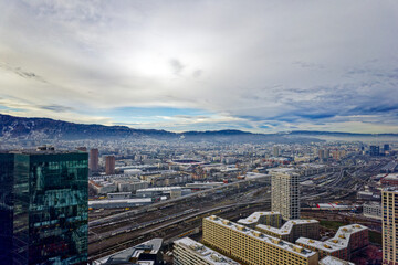 Aerial view of City of Zürich seen from industrial district with skyscraper and local mountain Uetliberg on a cloudy winter day. Photo taken December 20th, 2022, Zurich, Switzerland.