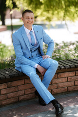 Obraz premium portrait of the groom's boyfriend in a blue suit smiling
