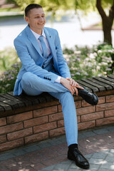 Obraz premium portrait of the groom's boyfriend in a blue suit smiling