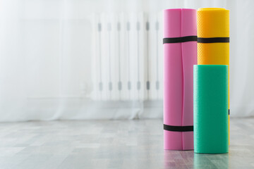 fitness mat on wooden floor at home