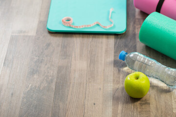 fitness mat on wooden floor, concept of health and sport