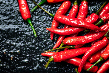 Pods of hot chili peppers on the table. 