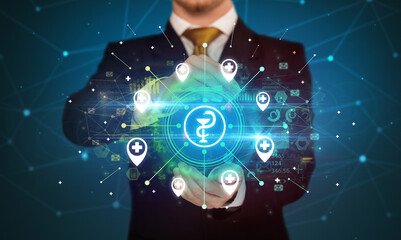 Hand holding healthcare icons concept