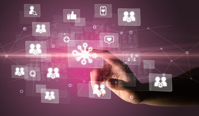 Hand pressing social media multimedia application screen with media icons on futuristic concept