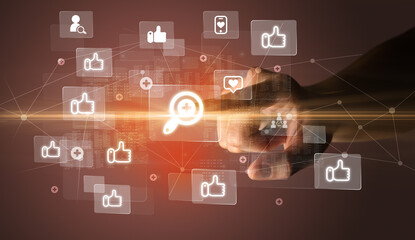Hand pressing social media multimedia application screen with media icons on futuristic concept