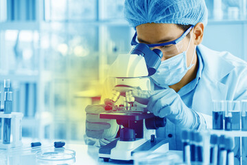 Scientists are using a microscope to test for viruses. or bacteria in the laboratory. Culture...