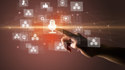 Hand pressing social media multimedia application screen with media icons on futuristic concept