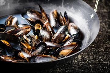 Mussels are cooked in a pot of water. 