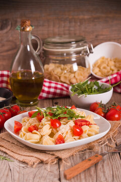 Orecchiette pasta with arugula and tomato.