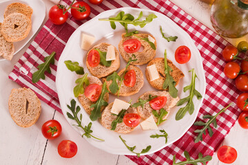 Friselle with cherry tomatoes and arugula.