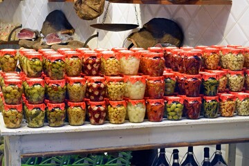 showcase of a traditional Tuscan grocery store with glass jars of pickled vegetables in the town of Scarperia in the province of Florence, Italy