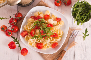 Orecchiette pasta with arugula and tomato.