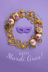Mardi Gras King Cake Muffins or Cupcakes, Carnival Masks on Purple Background.