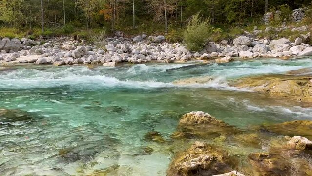 The Soca river flowing through a wild mountain landscape of the Julian Alps, Slovenia