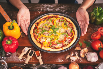 Close up Chef preparing pizza ingredients and spices preparatio on wood table, Homemade pizza cooking in the kitchen at home.