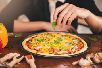 Close up Chef preparing pizza ingredients and spices preparatio on wood table, Homemade pizza cooking in the kitchen at home.