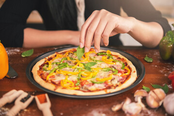 Close up Chef preparing pizza ingredients and spices preparatio on wood table, Homemade pizza cooking in the kitchen at home.