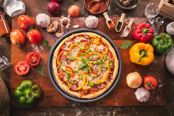 Top view of pizza ingredients and spices preparation on wood table, Homemade pizza cooking in the kitchen at home.