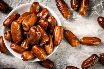 Full bowl with dates on the table. 