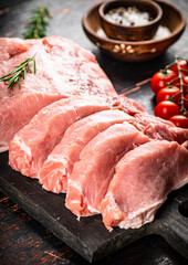 Sliced pork raw on a cutting board. 