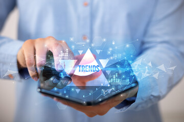 Businessman holding a foldable smartphone, business concept